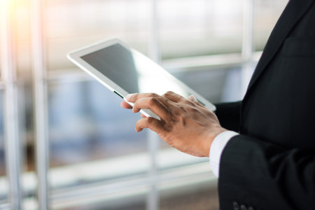 Business concept with man hand touching tablet computerの写真素材