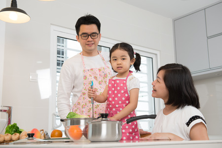 asian family cooking at kitchenの写真素材
