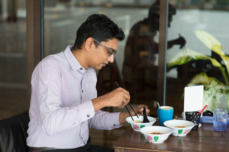 indian business male eating noodleの写真素材