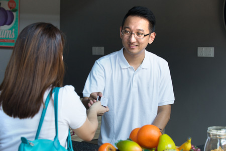 asian buying grocery at marketの写真素材