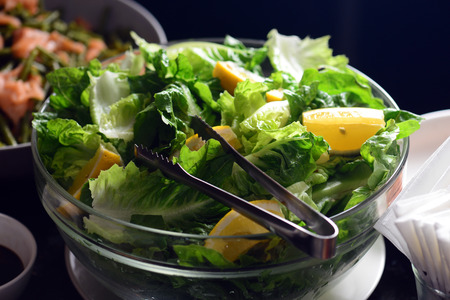 Salads in individual containers displayed on a buffetの写真素材