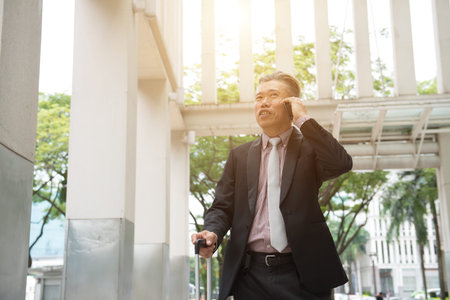 asian senior businessman travel with phoneの写真素材
