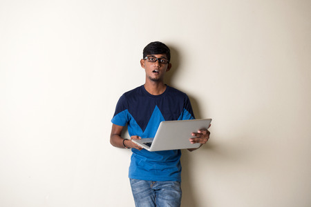 indian teenage male holding laptopの写真素材