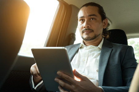middle eastern businessman inside a car passengerの写真素材