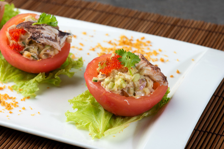 chinese crab meat salad with shark fin and roe inside tomatoの写真素材