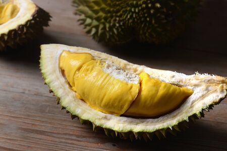 Durian riped and fresh ,durian peel with yellow colour on wooden table.の写真素材