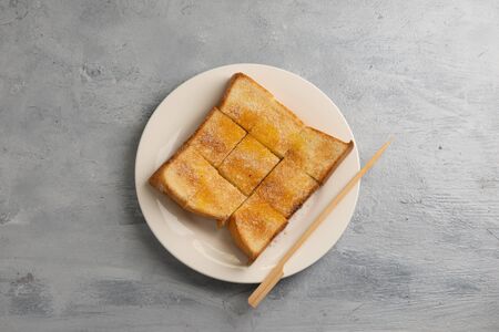 Bread toast with butter and condensed milk in plate.の写真素材