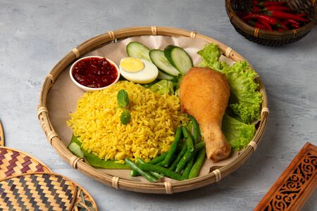 asian style Turmeric Spice rice with sambal and fried chickenの写真素材