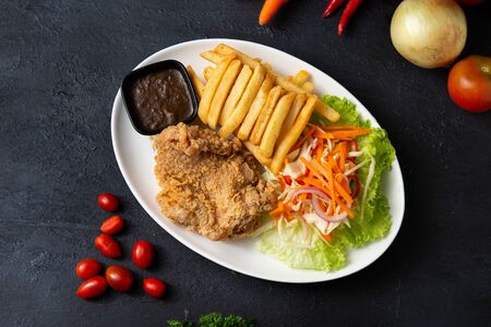 deep fried chicken steak with fries and black pepper sauceの写真素材