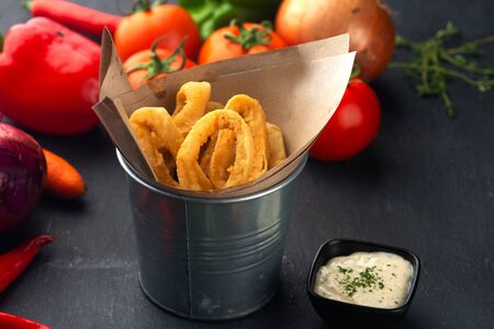 crispy calamari rings on basket with tartar sauceの写真素材