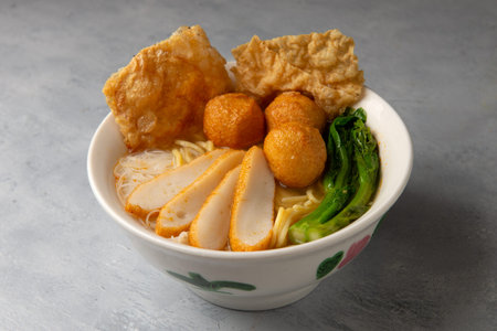 keow teow soup with fishballs and fishcakes chinese style with background