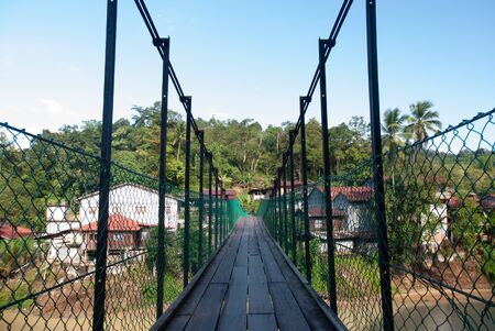 The suspension bridge span across  serves as a link between riverbanks in Sungai Lembing township.の写真素材