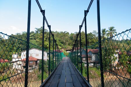 The suspension bridge span across  serves as a link between riverbanks in Sungai Lembing township.