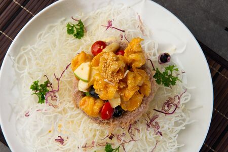 chinese crispy yam ring basket with sweet & sour prawnsの写真素材