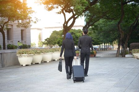 malay business team travelling with outdoor backgroundの写真素材