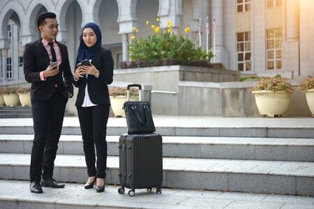 malay business team travelling with outdoor backgroundの写真素材