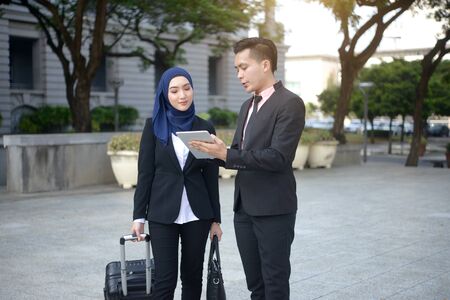 malay business team travelling with outdoor backgroundの写真素材