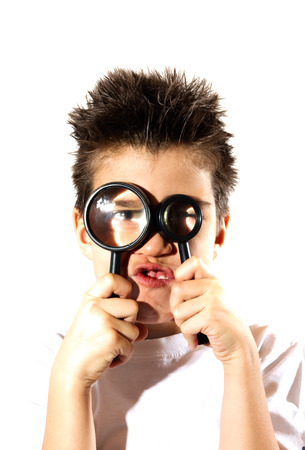 Boy looking through a two magnifying glasses, lensの写真素材