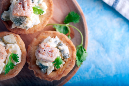 Tartlets with chicken, boiled eggs, cucumbers, spices and herbs.