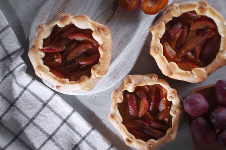 Tasty plum pie for tea. Plum pie Seasonal baking. Baking for tea. Yeast baking.の写真素材