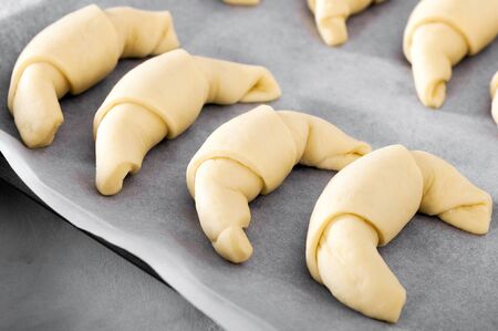 Preparation of the test for croissants. The dough is sliced in a triangle.の写真素材