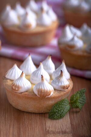 Elegant cupcakes with lemon Kurd and meringue scorched by a flame. Very tasty cupcakes. Tartlet filled with lemon cream (Kurd) and meringueの写真素材