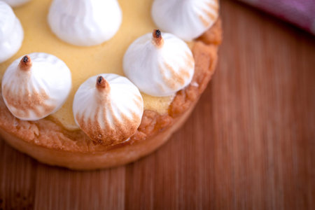 Elegant cupcakes with lemon Kurd and meringue scorched by a flame. Very tasty cupcakes. Tartlet...
