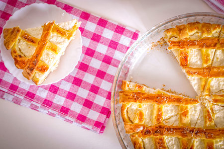 Sliced pie with cottage cheese and tea with lemon.の写真素材
