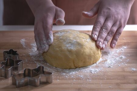 A cook is preparing a cookie dough. Shortbread dough for cookies.の写真素材
