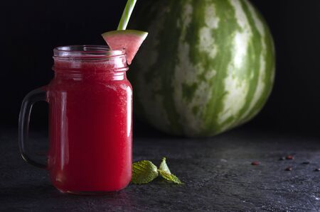 Watermelon drink in a jar with a pen. Cool drink.の写真素材