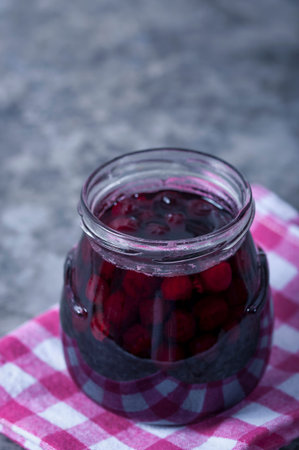 Cherry jam for breakfast. Cooking jam in the summer season. Cooking, preserving berries.