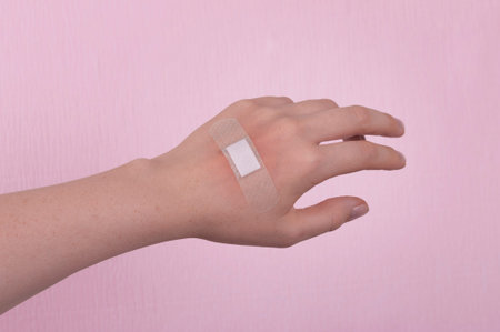 Injury on the arm, sealed with a plaster. Providing medical care.