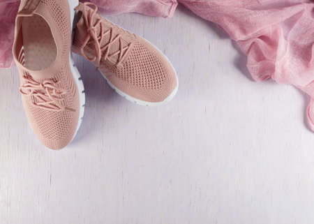 Pink women's lightweight, soft fabric shoes on a lilac background.の写真素材