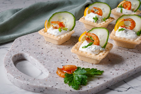Tartlets with stuffing lying on a stone board.の写真素材