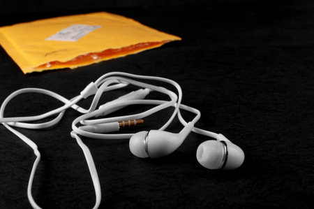 The headphones arrived in a yellow envelope. Products lie on a black background.