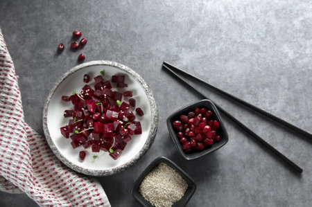 Fresh beetroot salad diced with pomegranate seeds, sesame seeds and herbs.の写真素材
