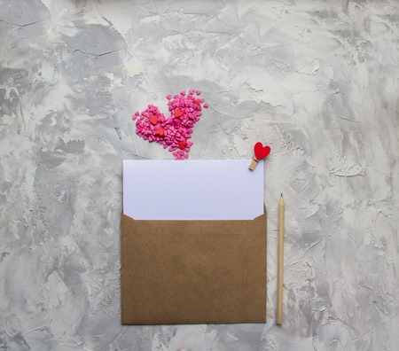 Letter with red and pink hearts on white gray background. Valentine day minimal concept Flat Lay Top View Copy Spaceの写真素材