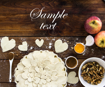 Recipe book cooking Apple pie with Hearts , Cinnamon, Nuts, walnuts, Flour, rolling pin, Spoon Wooden Background, top view, Copy Space, Rustic, Valentine`s Day Holiday Concept Loveの写真素材