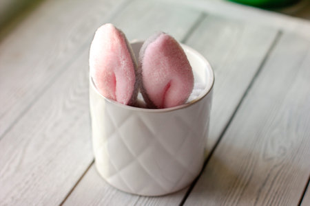 Easter bunny ears showing in flower pot. Toy bunny in a pot. Cute easter design, copy space for text