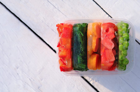 Frozen vegetables in a container. top view. harvesting and preserving vitamin veggies for winter....