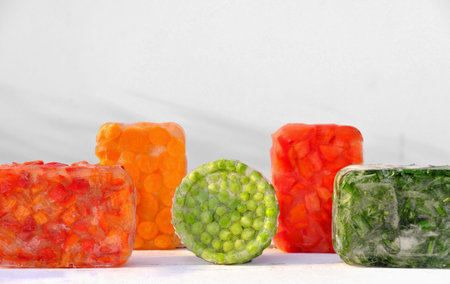 Frozen vegetables on wooden table. harvesting and preserving vitamin veggies for winter. frozen...
