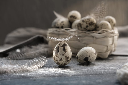 quail eggs in a basket and on a wooden table. rustic farmers organic product. local farming concept....