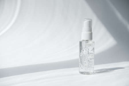 collagen peptides in a gel form. transparent hyaluronic acid cosmetic gel. copy space for text. sanitizer gel in sun shine. trendy direct light. face care product. hydrating and anti age cosmetic.の写真素材