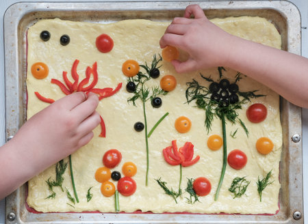 focaccia gardens trend. kids making focaccia art bread. little chef concept, social media trendy...