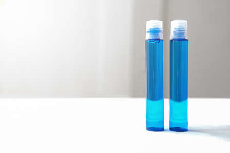 blue cosmetic liquid in plastic bottles. anti age collagen or hyaluronic acid. cosmetic for hair. anti hair loss concept. korean beauty product for young faceの写真素材