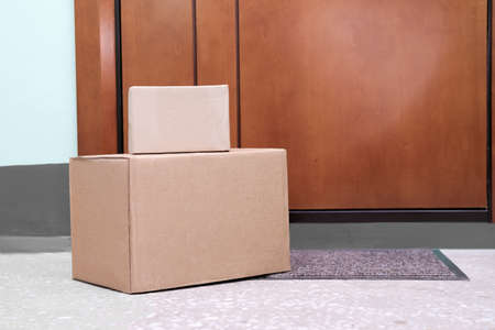 boxes left near house door. contactless delivery concept. safe shopping and delivery of online bought items. keep social distance to stay safe.の写真素材