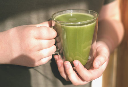 matcha oatmilk in human hands. non dairy drink for health care and cheerfulness. trendy japanese tea...