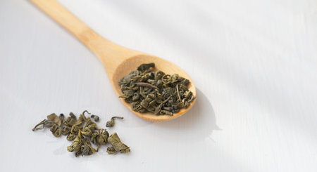 green tea leaves on white background. Floral tea for healthy morning and cheerful mood. herbal tea...