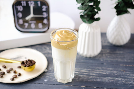 Iced frothy Dalgona Coffee, a trendy fluffy creamy whipped coffee. Korean drink latte espresso with...