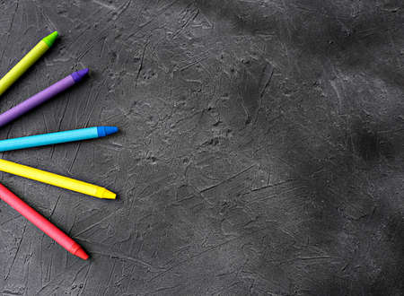 a bunch of crayon color pencils on a gray background. back to school concept. time to go to school after coronavirus lockdown.の写真素材